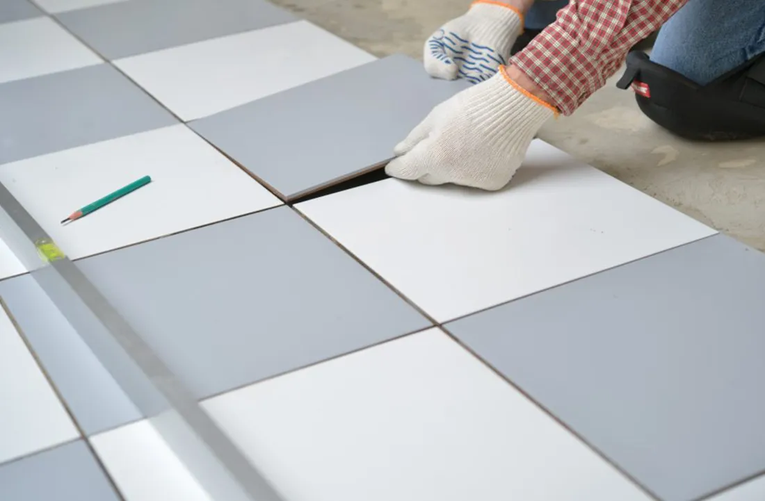 Interior Swimming Pool Cleaning. Caucasian Worker Cleaning Ceramic Sides of the Pool.